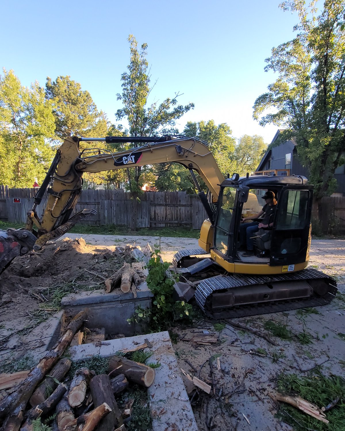 CAT excavator near a residential home