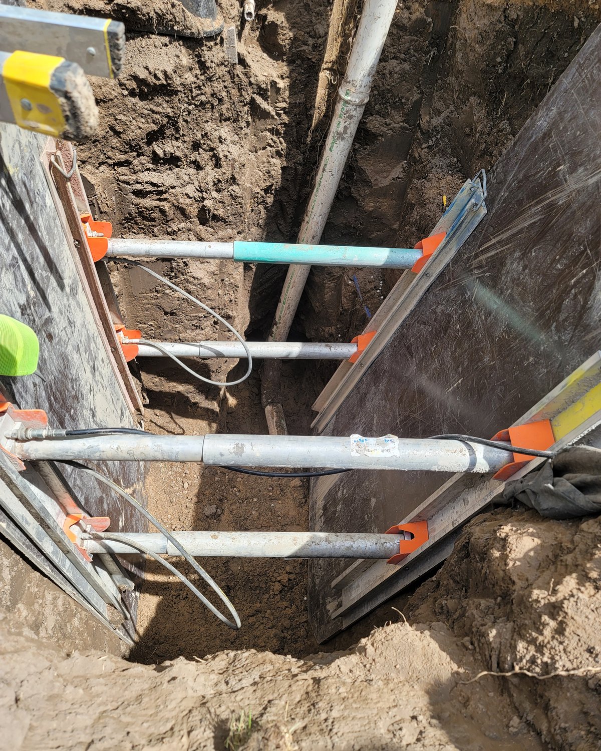 Color-coded electrical conduit run in trench