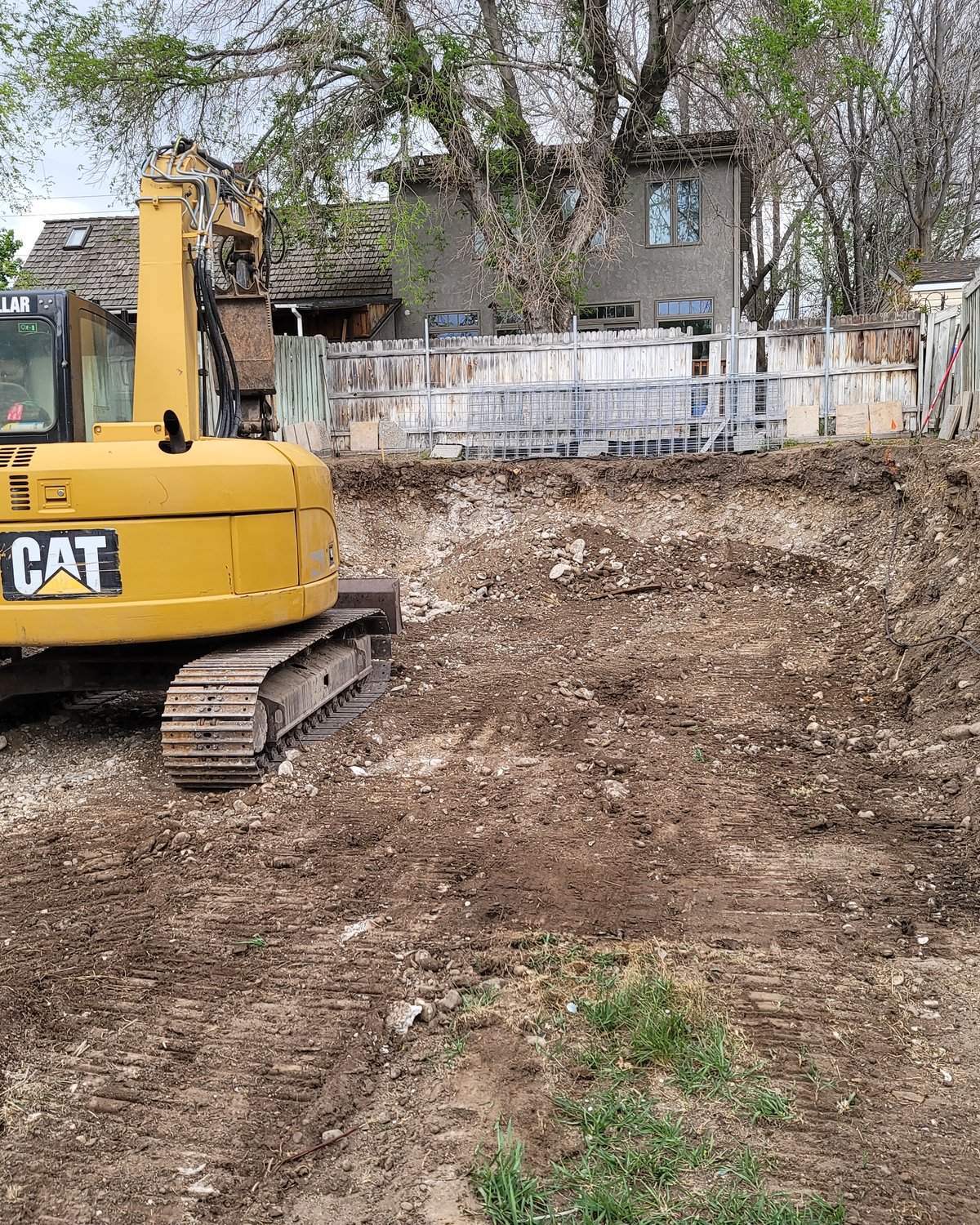 CAT excavator clearing a site