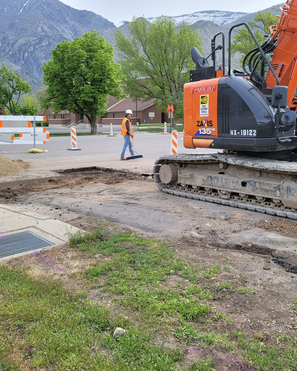 Excavator working a road job
