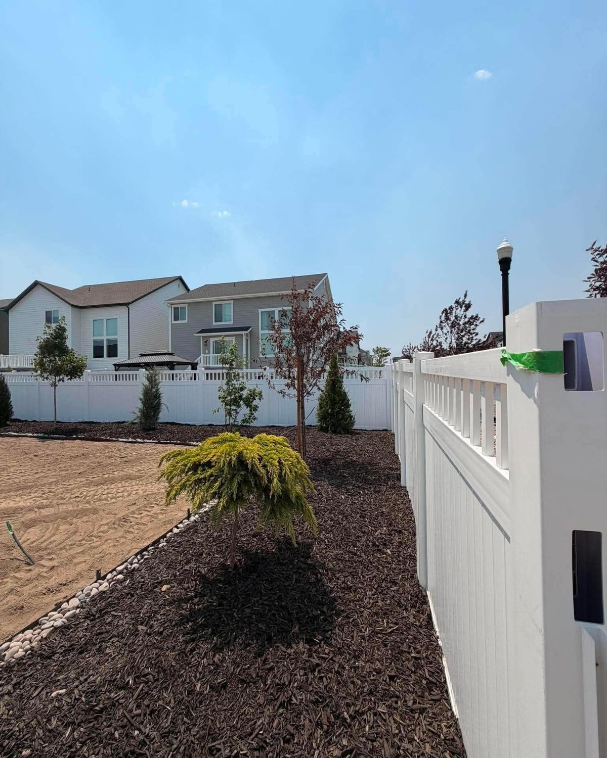 Vinyl fence with landscape and front yard