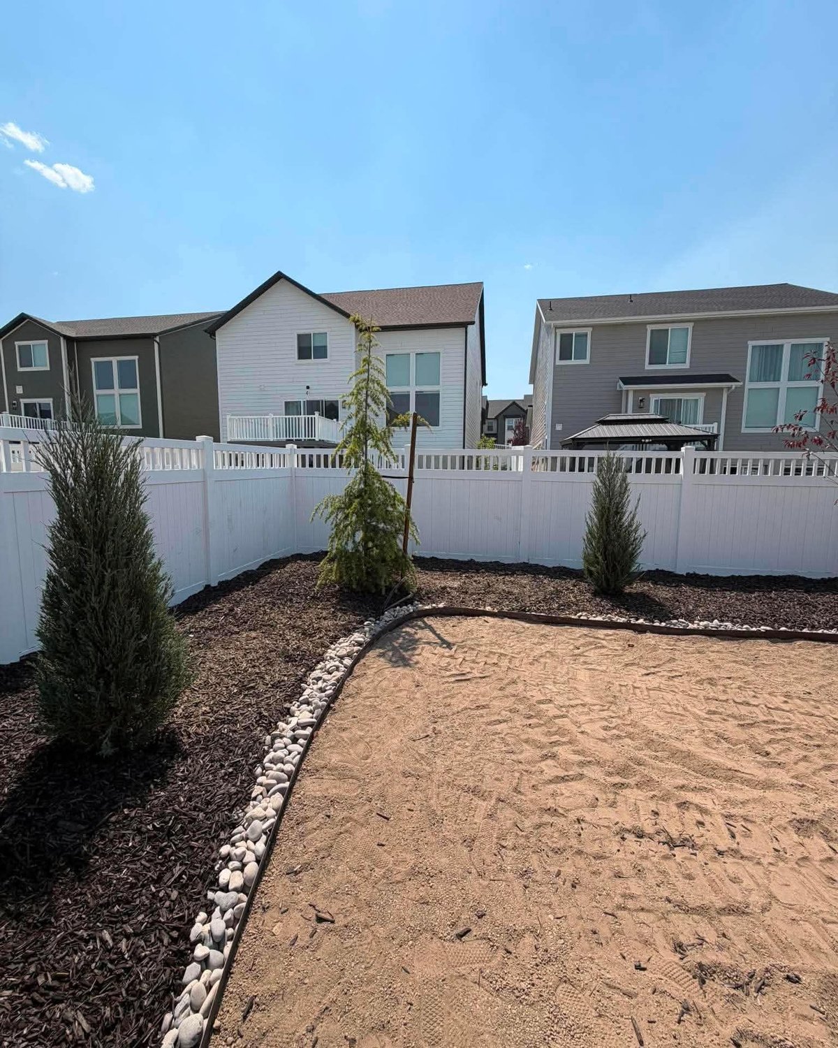 Finished landscape with mulched beds and trees