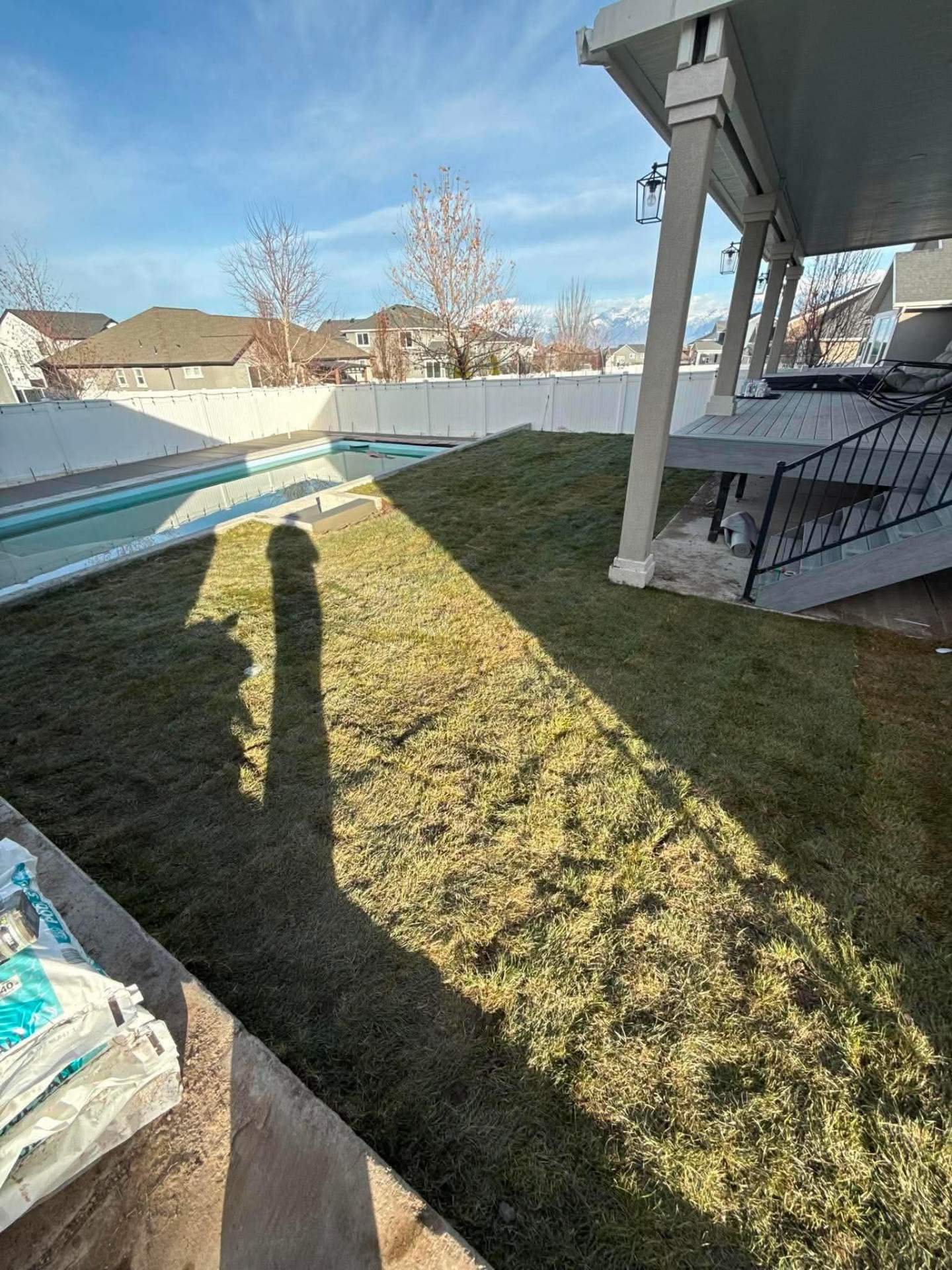 Fresh sod and grading around a backyard pool